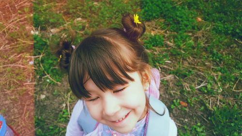 Portrait of cute girl lying on land