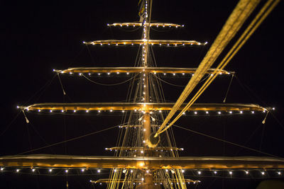 Illuminated bridge against sky at night