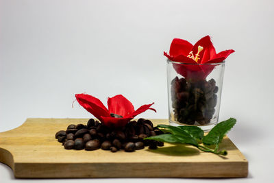 Close-up of red rose on table