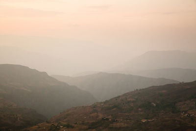 Scenic view of mountains against cloudy sky