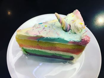 High angle view of cake on plate against black background