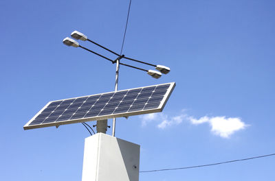 Low angle view of solar panel against blue sky during sunny day