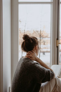 Woman with the book at the window