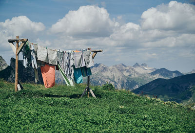 Clothes drying on field against sky