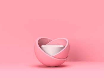 Close-up of heart shape over pink background