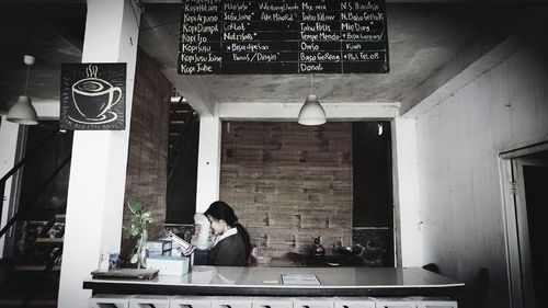 Woman standing in front of restaurant