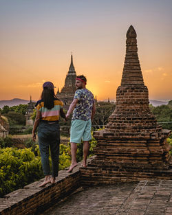 Rear view of woman standing in temple