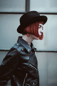 Midsection of woman wearing hat standing at home