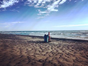 Garbage can on shore at beach