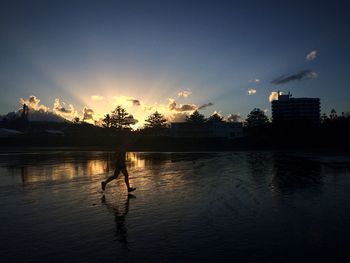 Scenic view of lake at sunset