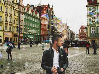 People on city street by buildings