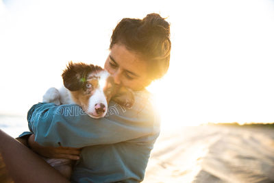 Man with dog against sky