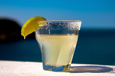 Close-up of drink in glass on table outdoors