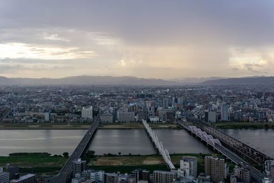 Aerial view of buildings in city against sky during sunset