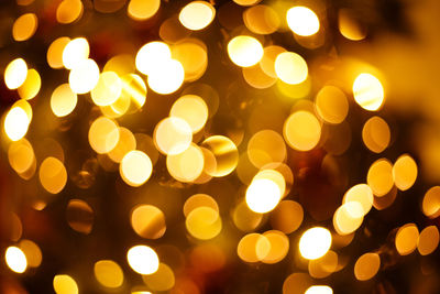 Defocused image of illuminated christmas lights at night