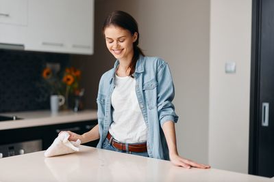 Side view of young woman working at home