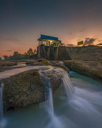 Scenic view of river against sky during sunset
