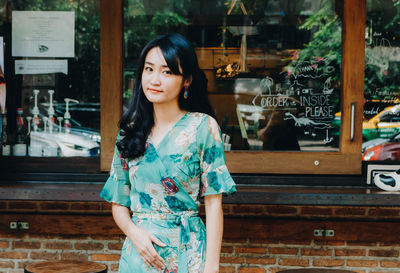 Portrait of smiling woman standing outdoors