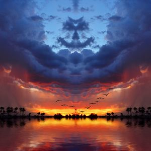 Scenic view of sea against cloudy sky at sunset