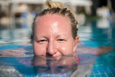 Close-up portrait of boy swimming in pool