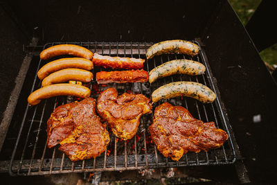 High angle view of meat on barbecue grill