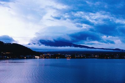 Scenic view of calm sea against mountain range