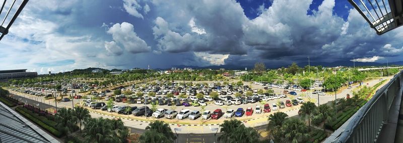 High angle view of cars in parking lot against sky