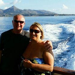 Portrait of happy young man in sea against sky