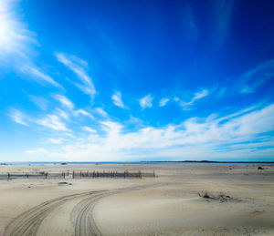 Scenic view of beach against cloudy sky