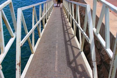 Low section of man walking on footbridge