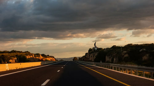 Highway against sky during sunset