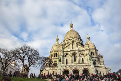 Low angle view of basilique du sacre coeur against cloudy sky