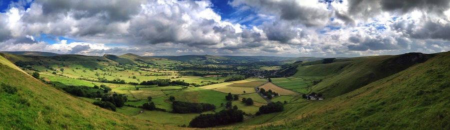 Panoramic view of mossy mountain and landscape against cloudy sky