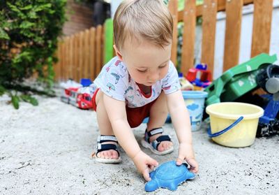 A little cute boy of one and a half years plays with toys at the playground. adorable toddler