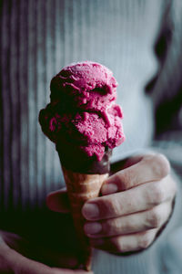 Midsection of hand holding ice cream