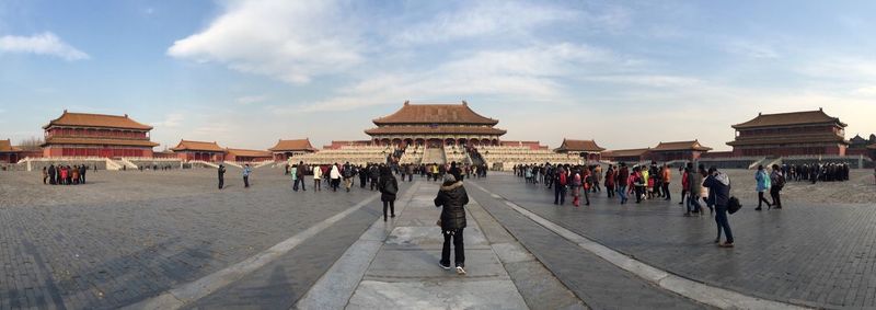 Panoramic shot of people at hall of supreme harmony against sky