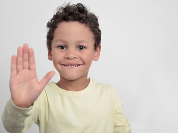 Portrait of smiling boy against white background