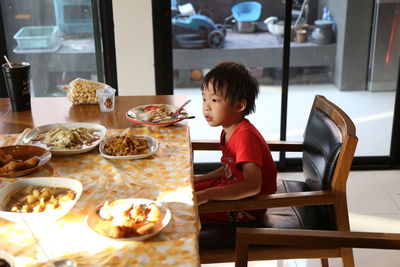 Boy sitting on table