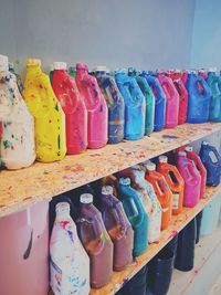 Multi colored bottles on shelf