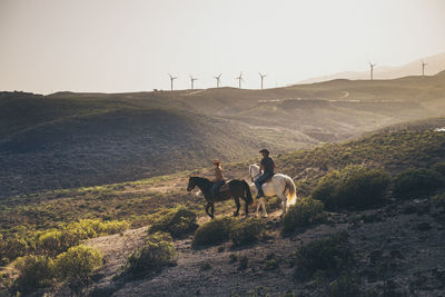 Friends horseback riding on mountain