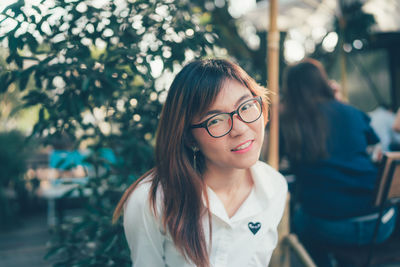 Portrait of young woman standing outdoors