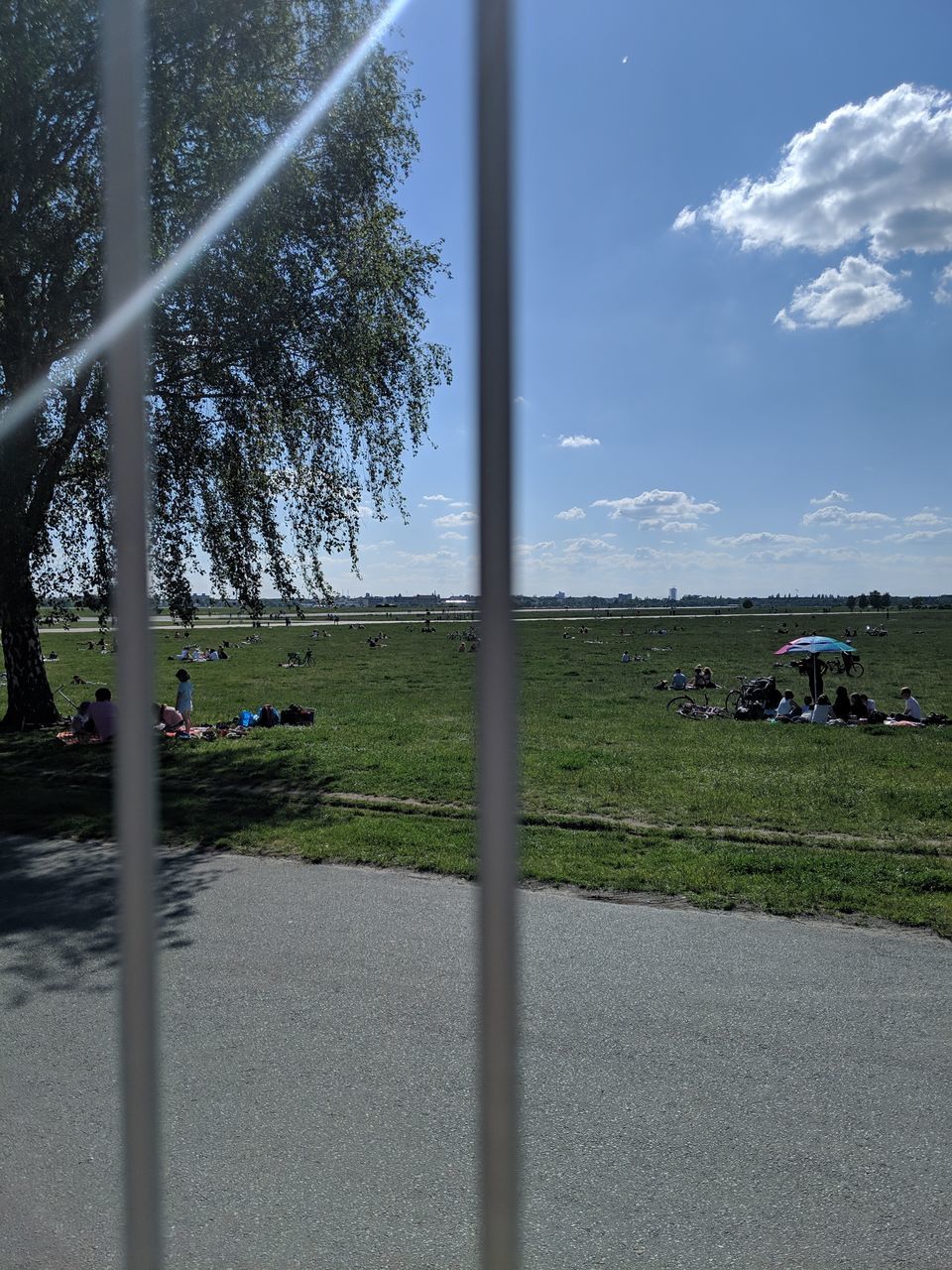 ROAD AMIDST FIELD AGAINST SKY SEEN THROUGH CAR WINDSHIELD