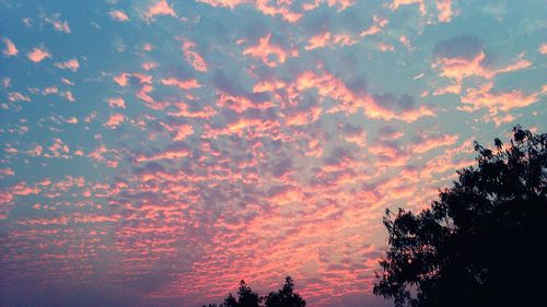 Low angle view of cloudy sky at sunset