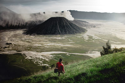 High angle view of man looking at volcanic landscape