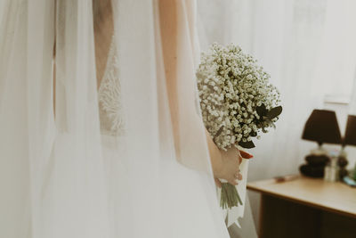 Portrait of a beautiful caucasian bride with a bouquet of boutonnieres.