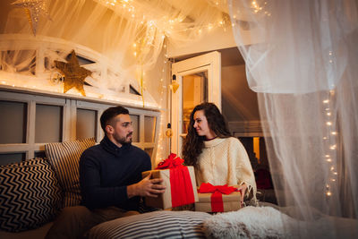 Young couple sitting in corridor