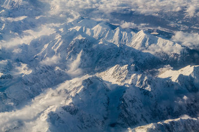 Aerial view of snowcapped mountains against sky