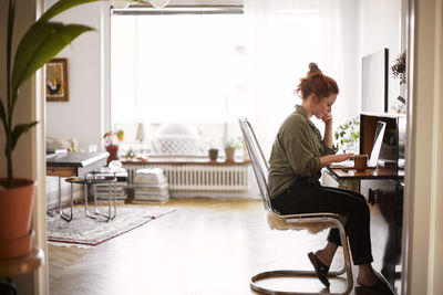 Woman using laptop in living room