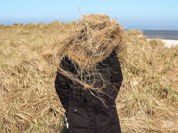 Rear view of man standing on field