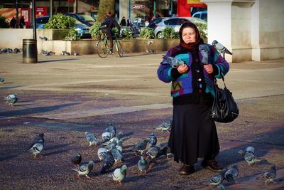 Portrait of smiling young woman with birds